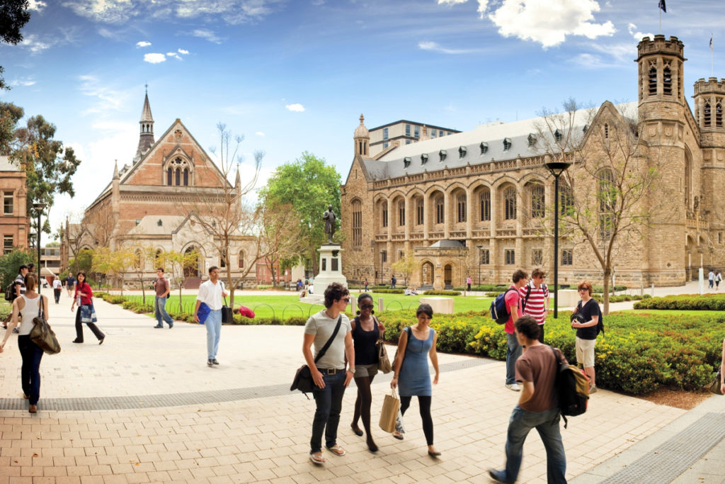 Adelaide University building with students walking in front.
