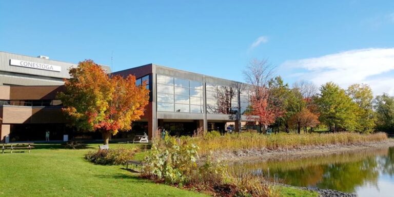 Conestoga College building with trees and a pond